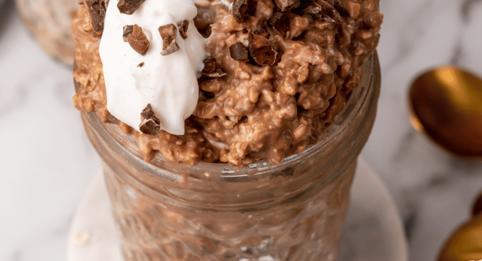 Healthy chocolate overnight oats with yogurt, protein, and fiber in a glass jar. Perfect for quick,.