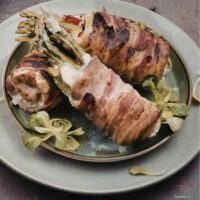 asaparagus stuffed chicken thighs on a plate