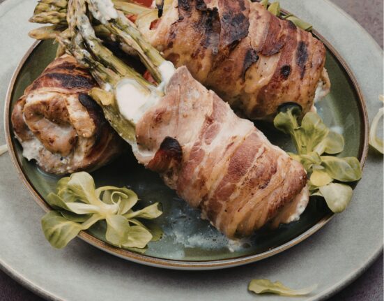 asaparagus stuffed chicken thighs on a plate