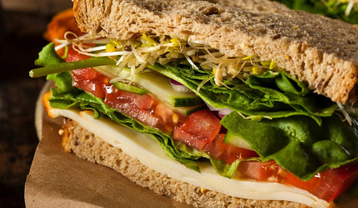 Close up image of hummus sandwich with veggies