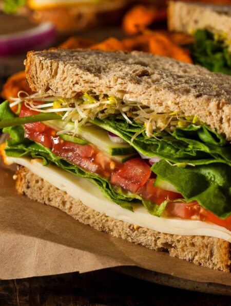 Close up image of hummus sandwich with veggies
