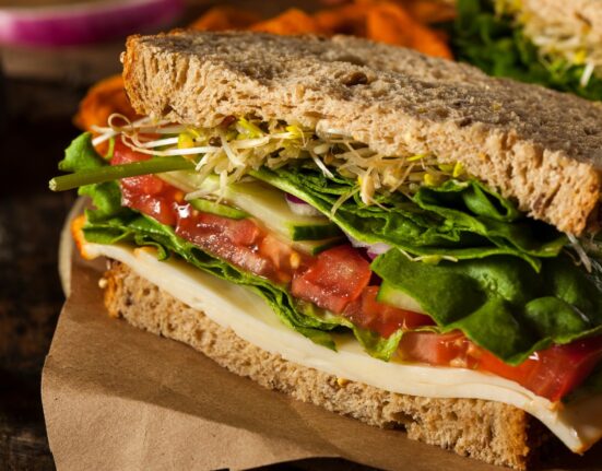Close up image of hummus sandwich with veggies