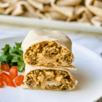 sausage and egg breakfast burrito on a plate.