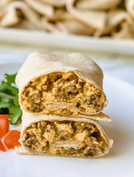 sausage and egg breakfast burrito on a plate.
