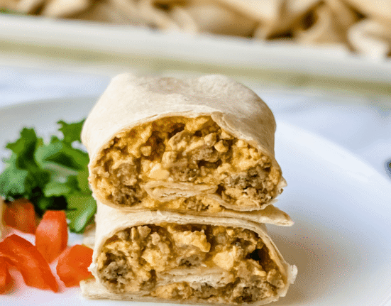 sausage and egg breakfast burrito on a plate.