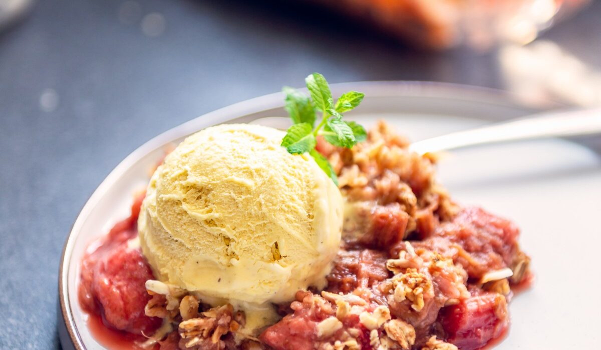 Strawberry Rhubarb Crisp on a plate with ice cream