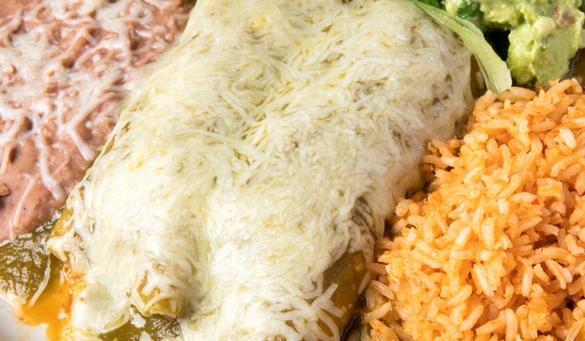 Overhead image of Turkey Enchiladas on a plate with beans and rice