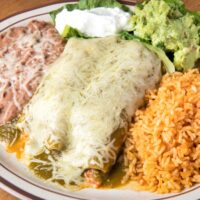 Overhead image of Turkey Enchiladas on a plate with beans and rice