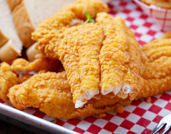 Close up image of air fryer catfish with a bite taken out of it