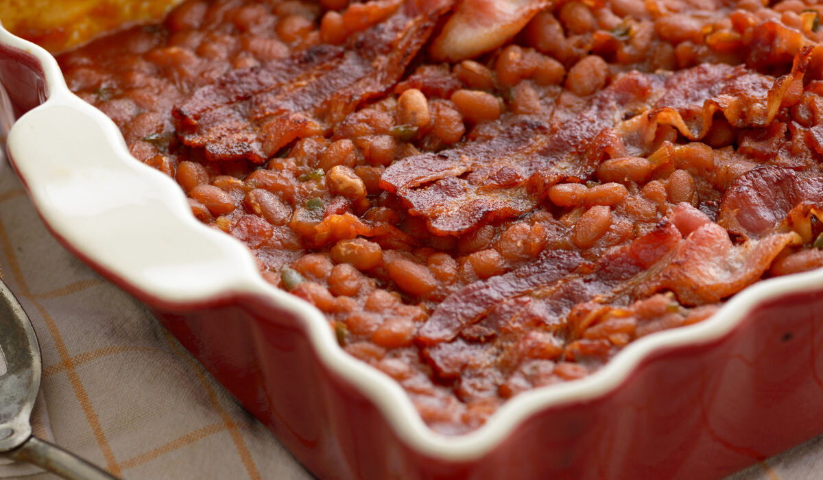 Baked Beans and Bacon in a red baking dish