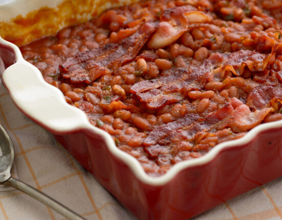 Baked Beans and Bacon in a red baking dish
