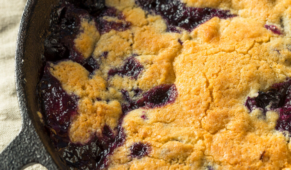 Close up image of Blueberry Cobbler in a cast iron pan