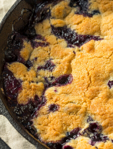 Close up image of Blueberry Cobbler in a cast iron pan
