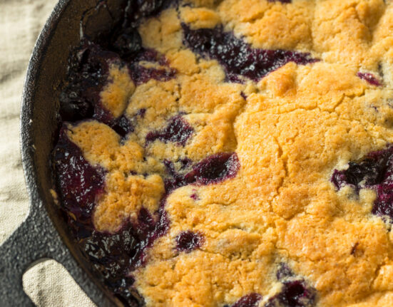 Close up image of Blueberry Cobbler in a cast iron pan