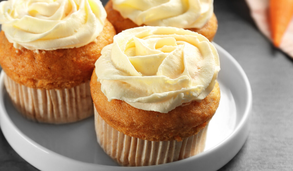 Close up image of three carrot muffins on a plate
