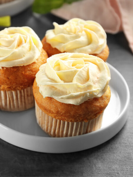 Close up image of three carrot muffins on a plate