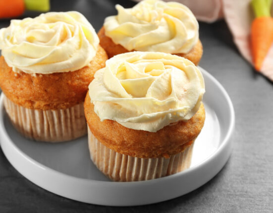 Close up image of three carrot muffins on a plate