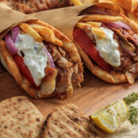 Two Chicken Gyros wrapped in parchment paper