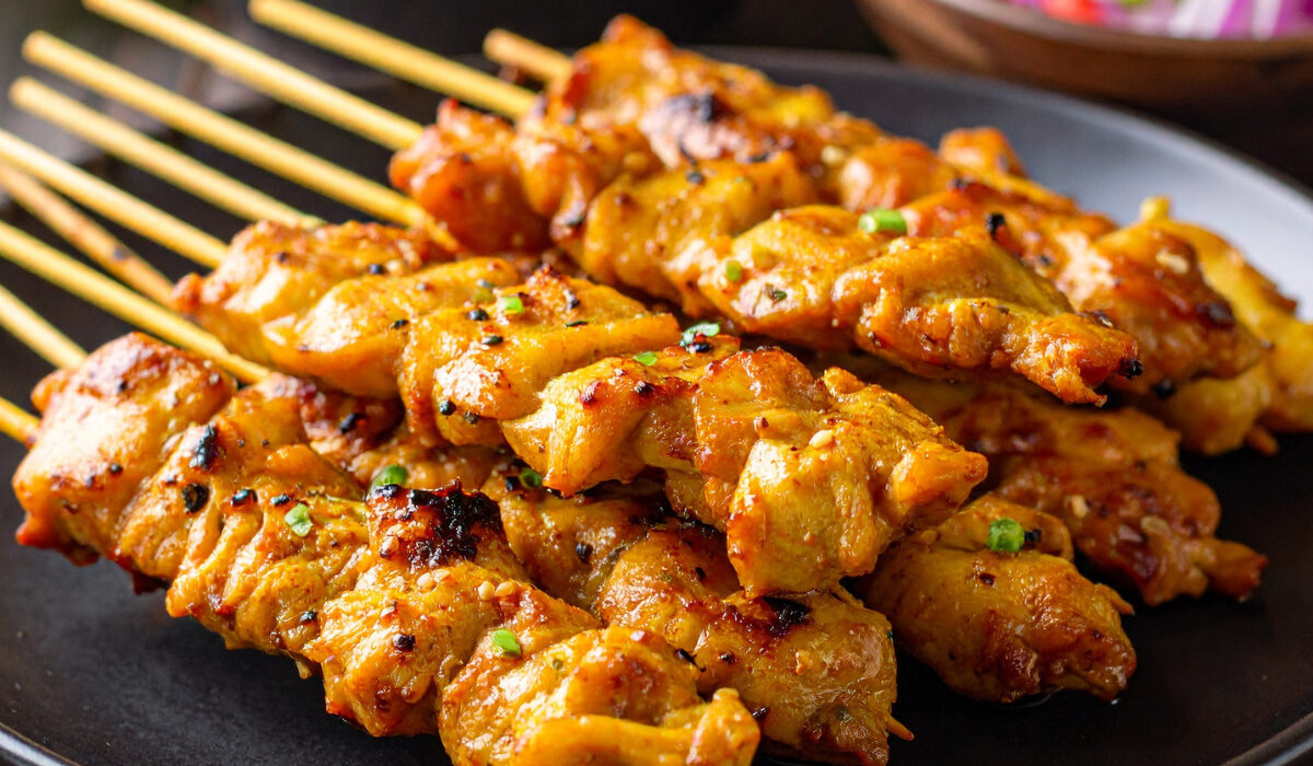 Close up image of Chicken Satay stacked on a plate