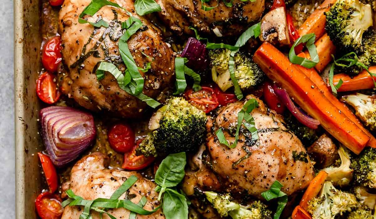 Overhead view sheet pan filled with balsamic marinated chicken and veggies
