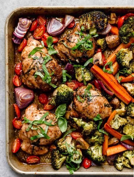 Overhead view sheet pan filled with balsamic marinated chicken and veggies