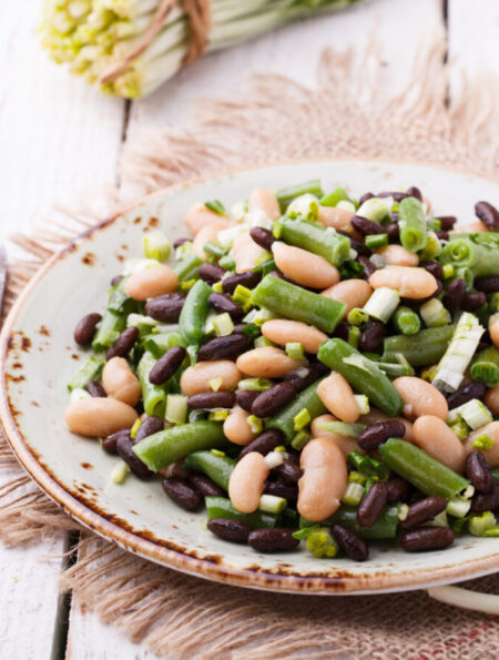 Three Bean Salad on a plate on a rustic backdrop