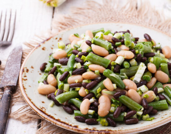 Three Bean Salad on a plate on a rustic backdrop