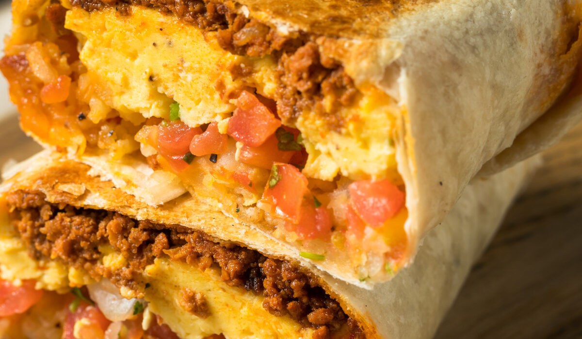 A chorizo breakfast burrito cut in half and stacked on top of each other