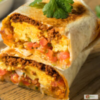 A chorizo breakfast burrito cut in half and stacked on top of each other