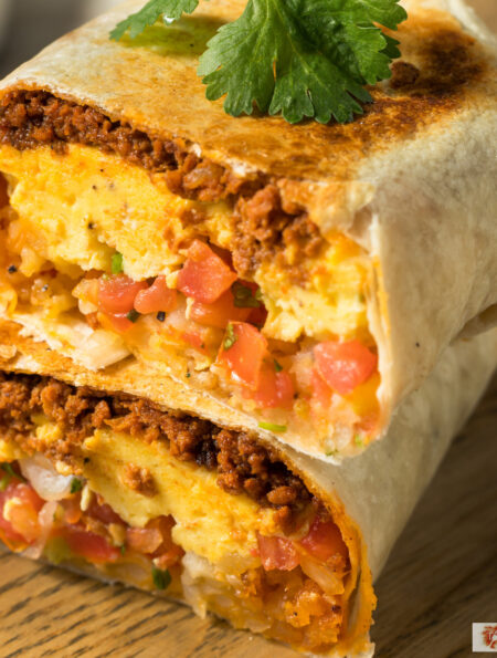 A chorizo breakfast burrito cut in half and stacked on top of each other