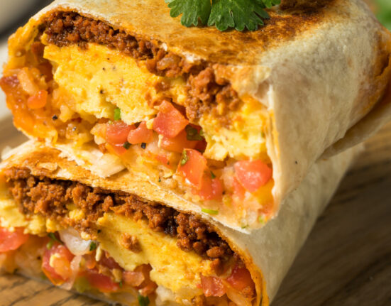 A chorizo breakfast burrito cut in half and stacked on top of each other
