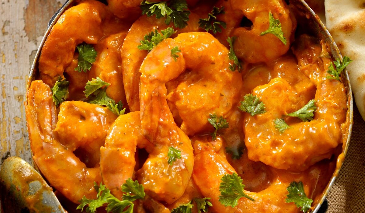 Overhead image of Curry Shrimp in a pan with cilantro for garnish