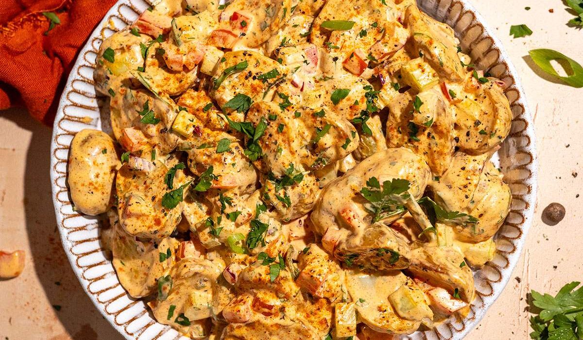 Cajun potato salad recipe with roasted potatoes, creamy dressing and fresh herbs.