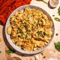 Cajun potato salad recipe with roasted potatoes, creamy dressing and fresh herbs.