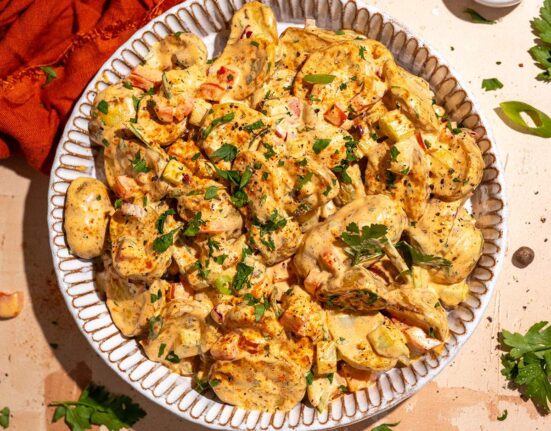 Cajun potato salad recipe with roasted potatoes, creamy dressing and fresh herbs.
