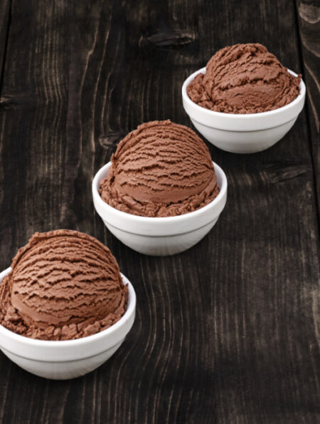 dairy free chocolate ice cream scoops in white bowls