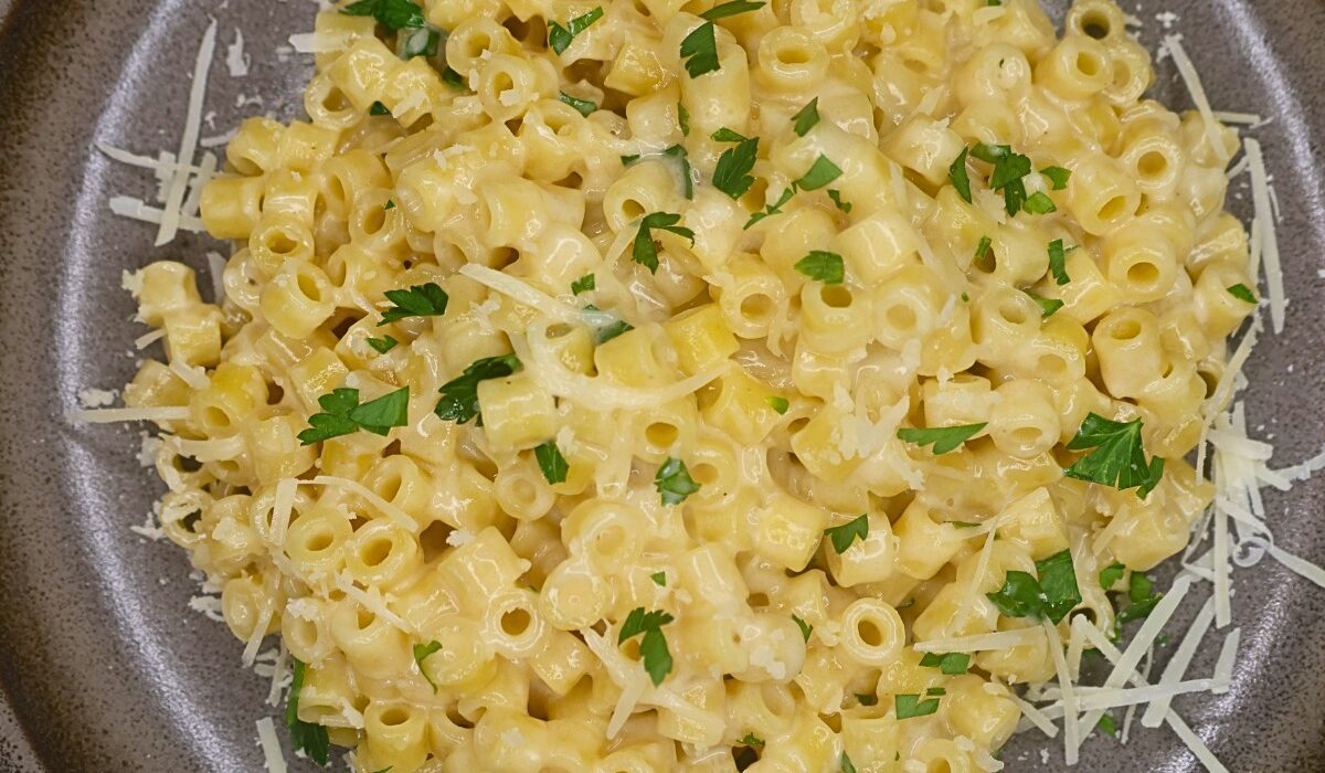 Overhead image of Viral Ditalini pasta on a plate with parmesan cheese and parsley