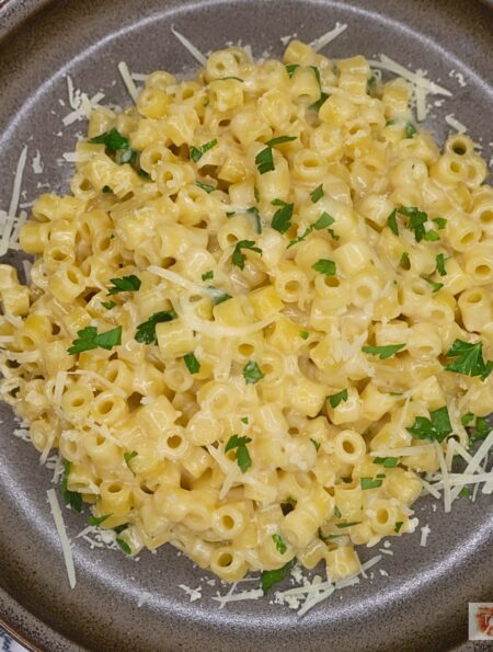 Overhead image of Viral Ditalini pasta on a plate with parmesan cheese and parsley