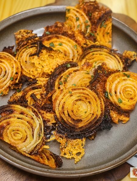 Overhead image of onion chips on a plate