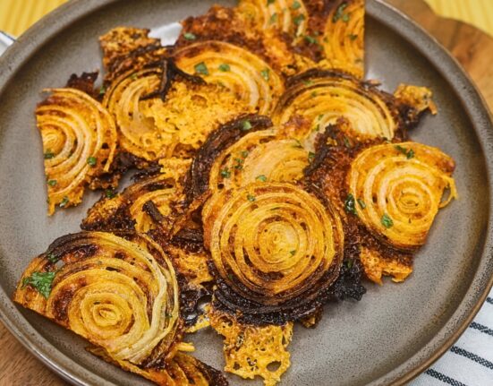 Overhead image of onion chips on a plate