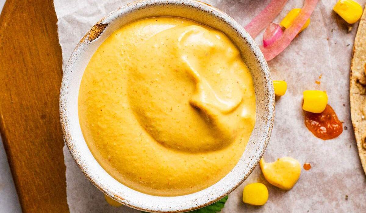 A small ramekin of vegan nacho cheese sauce.