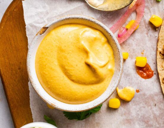 A small ramekin of vegan nacho cheese sauce.